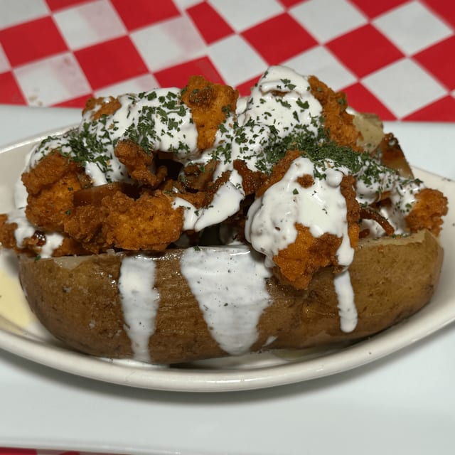 Bacon, Popcorn Chicken, & Ranch Stuffed Potato.